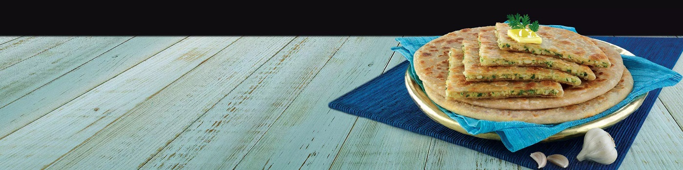 Lasooni Aloo on plate on blue table
